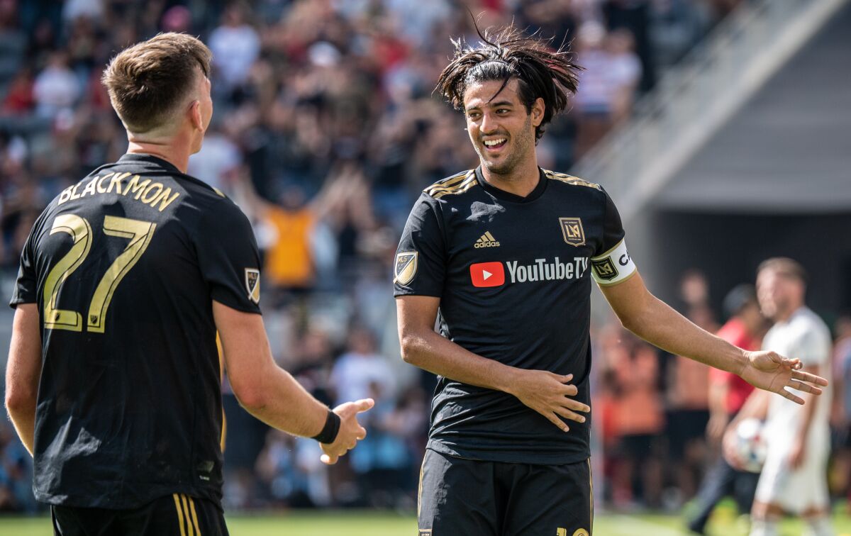 LAFC star Carlos Vela celebrates with teammate Tristan Blackmon after scoring against Sporting Kansas City on Oct. 6.