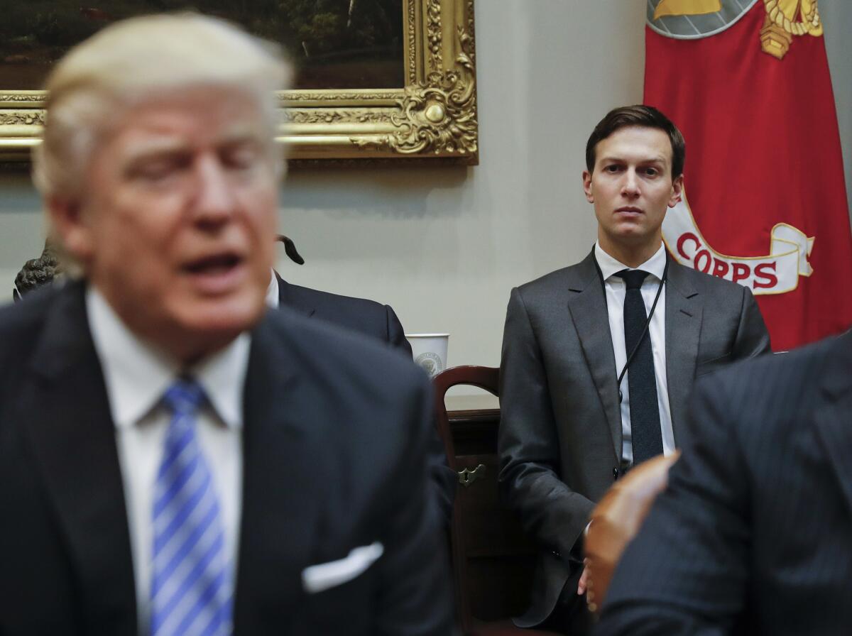 White House Senior Adviser Jared Kushner, right, listens to President Trump speak during a breakfast with business leaders in the Roosevelt Room of the White House in Washington on Jan. 23.