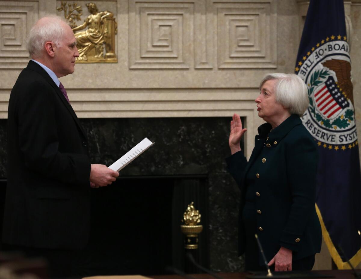 Daniel Tarullo, a member of the Federal Reserve Board of Governors, swears in Janet L. Yellen as the central bank's chairwoman in 2013.