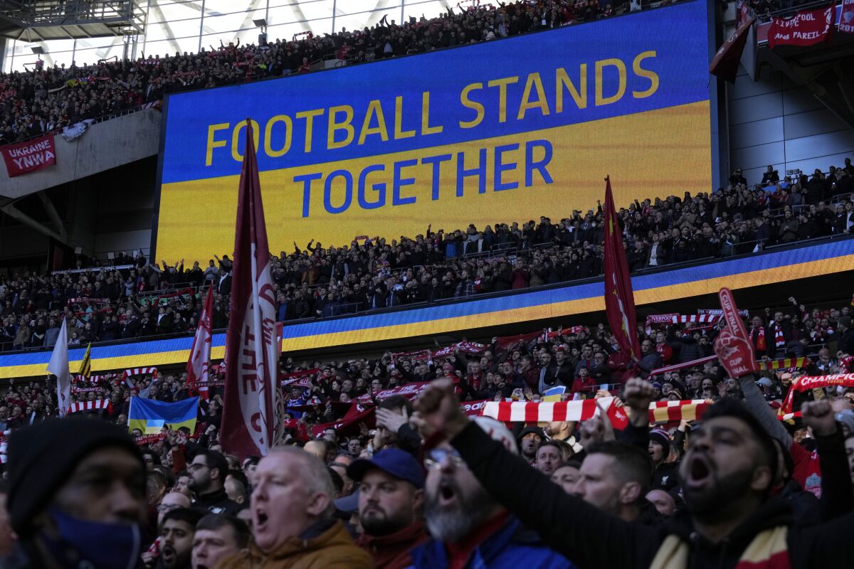 A video screen displays the Ukrainian flag, during the English League Cup final soccer match between Chelsea and Liverpool at Wembley stadium in London, Feb. 27, 2022. (AP Photo/Alastair Grant)