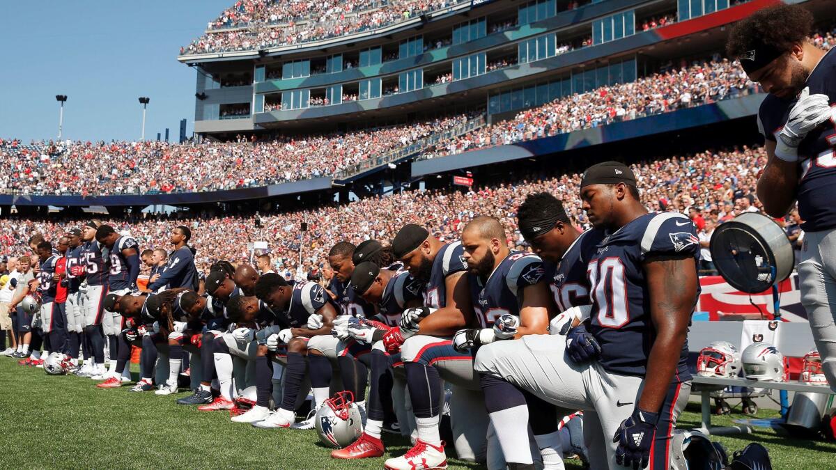 Several New England Patriots players kneel during the national anthem before their game against the Houston Texans on Sept. 24.