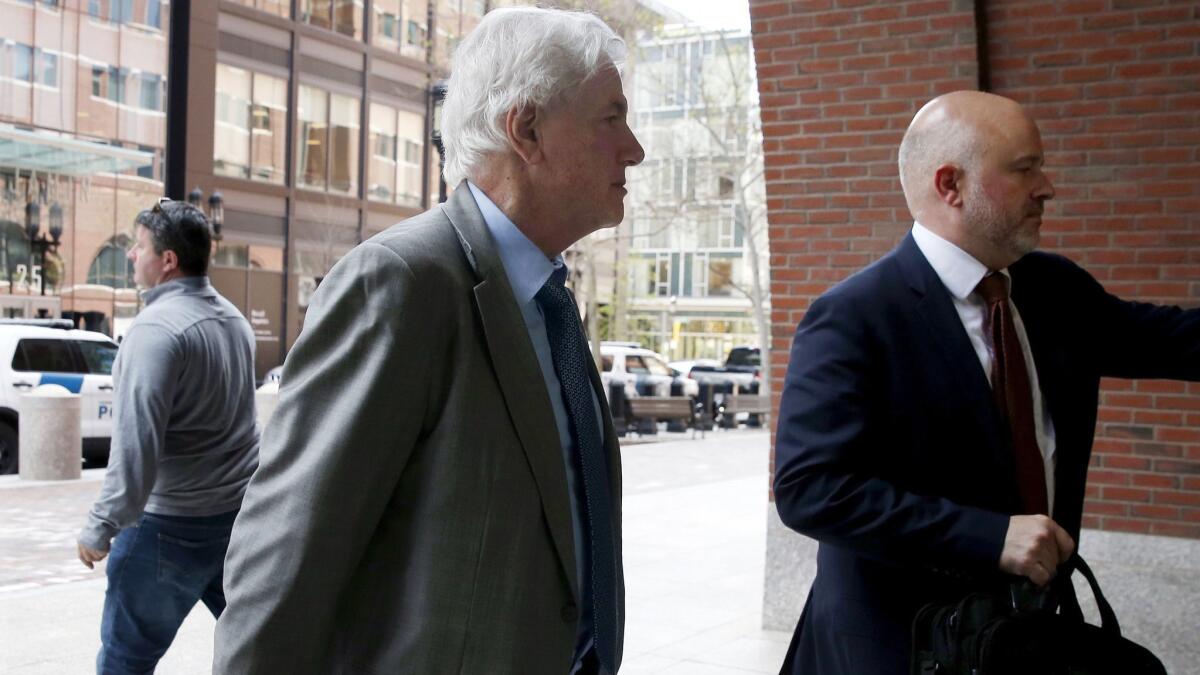 Gregory Abbott, center, arrives at federal court Wednesday in Boston, where he pleaded guilty to charges in a nationwide college admissions bribery scandal.