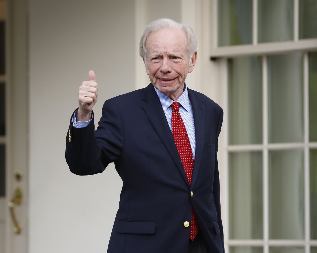 FILE - Former Connecticut Sen. Joe Lieberman gives a 'thumbs-up' as he leaves the West Wing of the White House in Washington, Wednesday, May 17, 2017. Lieberman details in a new book how aid from top Republicans helped him win reelection against a more left-leaning Democrat and a Republican. The Hartford Courant reported Monday, Oct. 18, 2021 that Lieberman provides new details in the book about help from Karl Rove, a top advisor to then-President George Bush. (AP Photo/Pablo Martinez Monsivais)
