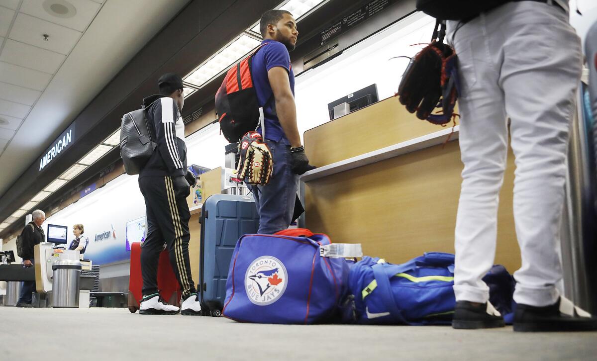 Steward Berroa, center, and teammates from the Dominican Republic at Tampa International Airport.