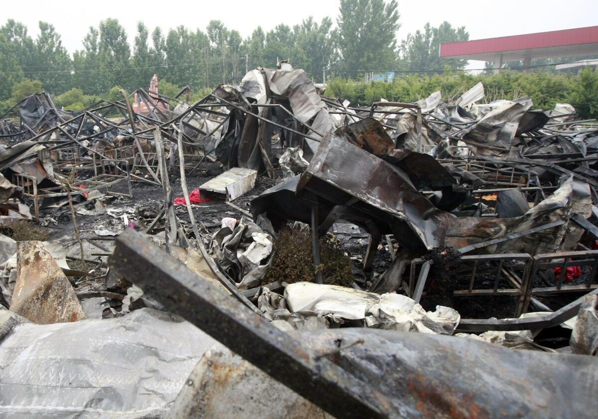 Charred building frames and bedsteads are seen May 26 after a fire broke out in a nursing home in central China's Henan province. The fire left at least 38 people dead, officials said.