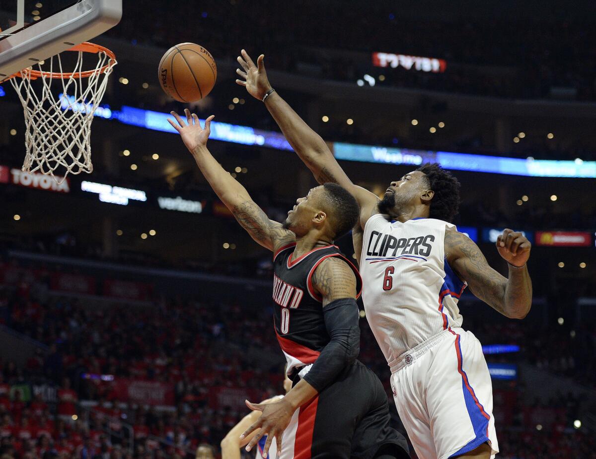 Clippers center DeAndre Jordan blocks a layup by Trail Blazers guard Damian Lillard during the first half of Game 1 of the Western Conference playoffs on Sunday.