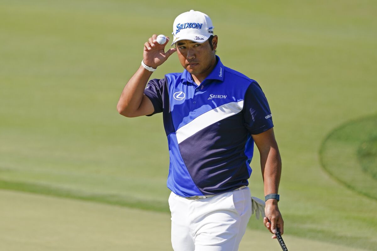Hideki Matsuyama tips his hat to the gallery after sinking a putt on the eighth green during the second round of the Arnold Palmer Invitational golf tournament Friday, March 4, 2022, in Orlando, Fla. (AP Photo/John Raoux)