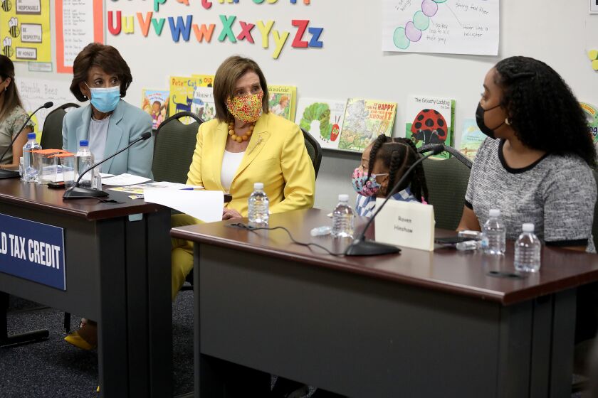 LOS ANGELES, CA - AUGUST 12: Rep. Maxine Waters, left, D-Los Angeles, and House Speaker Nancy Pelosi, D-San Francisco, listen to Raven Hinshaw, during a news conference to discuss the importance of the Child Tax Credit at the Ethel Bradley Early Education Center Thursday, Aug. 12, 2021 in Los Angeles, CA. (Gary Coronado / Los Angeles Times)