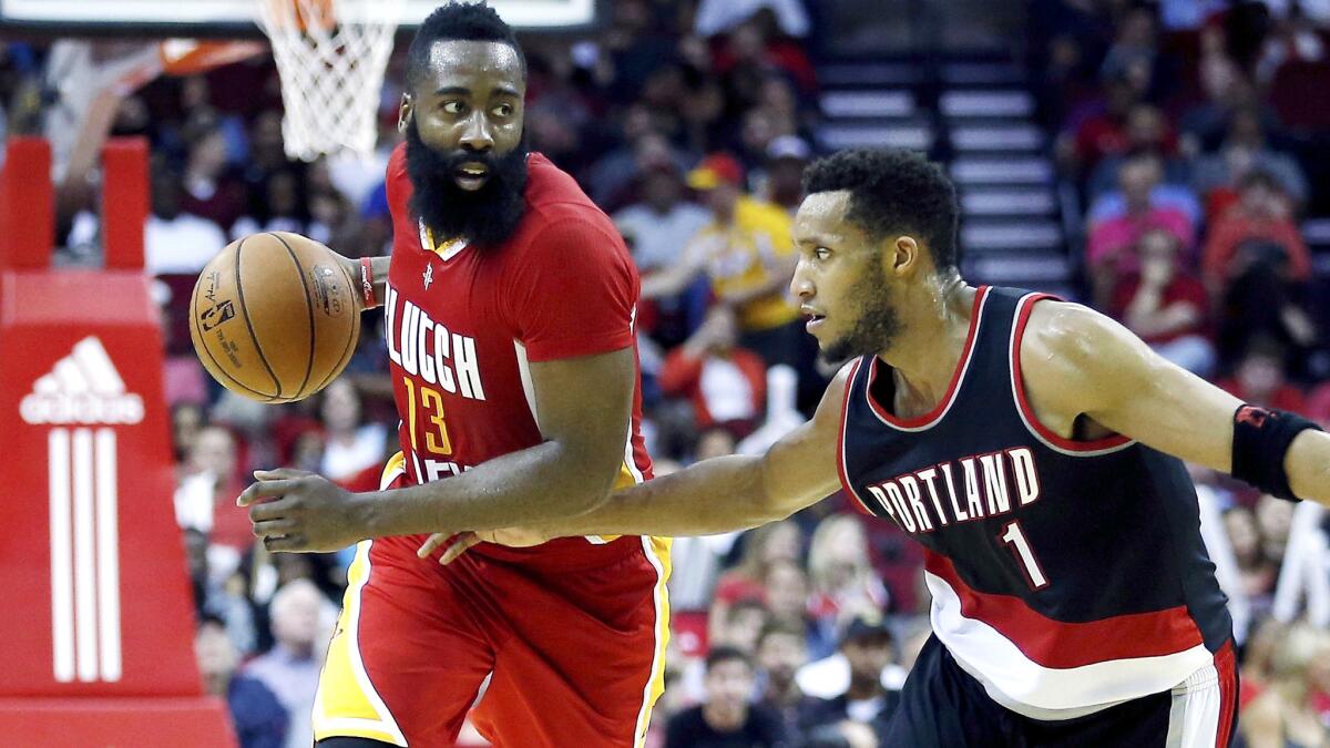 Guard James Harden is pressured by Trail Blazers guard Evan Turner (1) while bringing the ball up court for the Rockets in the second half Thursday.