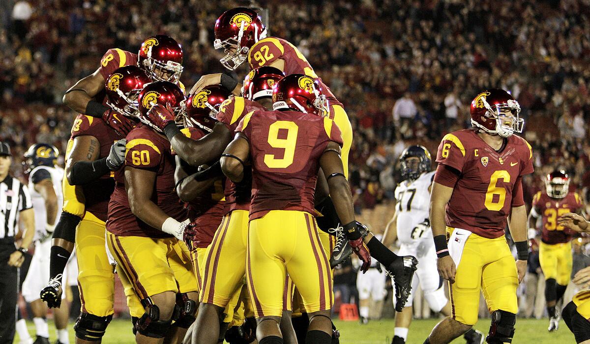 USC wide receiver Nelson Agholor is mobbed by teammates after catching a 10-yard touchdown pass from quarterback Cody Kessler (6) in the first half Thursday against Cal at the Coliseum.