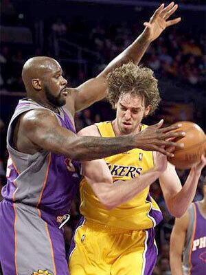 Suns center Shaquille O'Neal applies defensive pressure against Lakers center Pau Gasol in the first quarter Thursday.