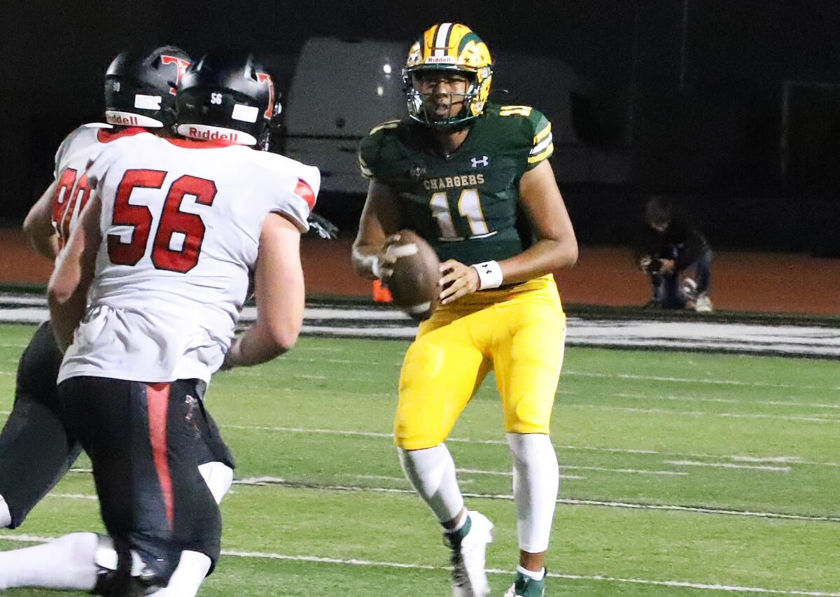 Edison quarterback Save Niumata (11) looks for a open receiver against San Clemente on Friday night.