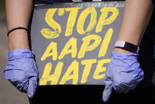 FILE - A person holds a sign and attends a rally to support stop AAPI (Asian Americans and Pacific Islanders) hate at the Logan Square Monument in Chicago, on March 20, 2021. Despite ongoing efforts to combat anti-Asian racism that arose after the pandemic, a third of Asian Americans and Pacific Islanders say they have experienced an act of abuse based on their race or ethnicity in the last year. (AP Photo/Nam Y. Huh, File)