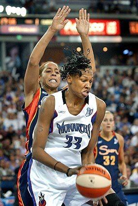 Connecticut Sun defender Nykesha Sales, left, tries to hold off Sacramento Monarchs center Yolanda Griffith during the first half of game four of the WNBA Finals in Sacramento, Calif.