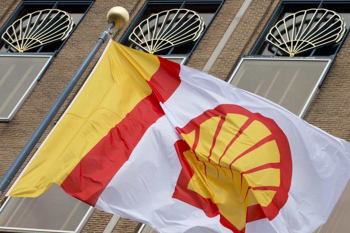 A flag bearing the logo of Royal Dutch Shell flies outside the company's main office in The Hague, Netherlands, on April 7, 2014.