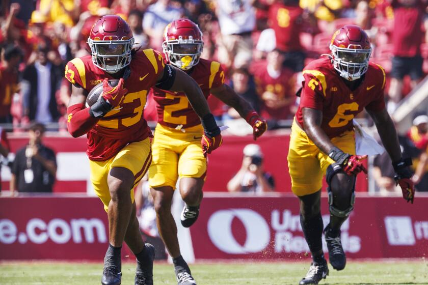 USC linebacker Desman Stephens II returns an interception 42 yards against Penn State on Saturday at the Coliseum.