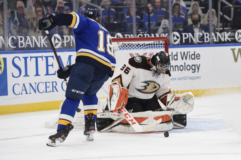 Ducks goalie John Gibson blocks a shot from the St. Louis Blues' Robert Thomas, left, in the second period March 26, 2021.