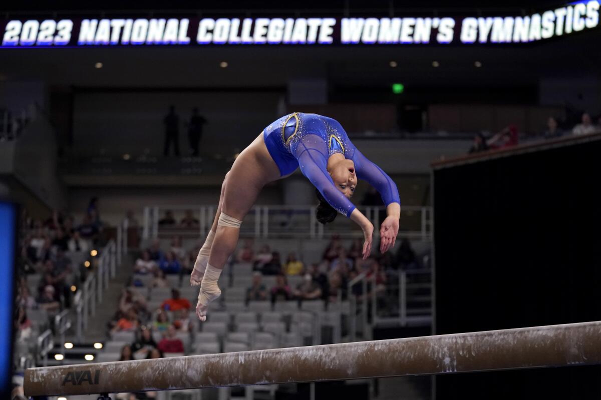 UCLA's Emma Malabuyo competes on the balance beam during the NCAA championship semifinals.