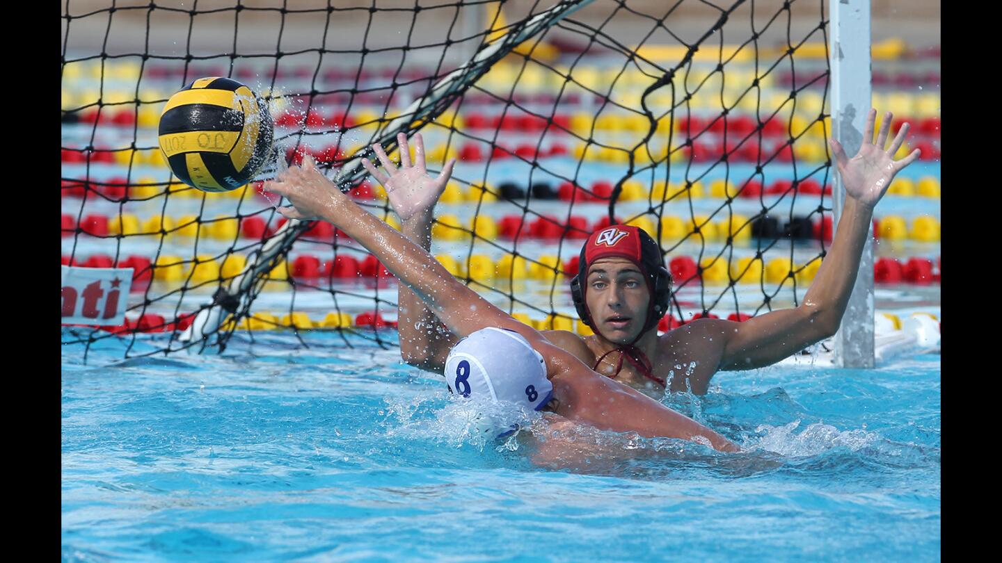 Ocean View's Kyle Graham shoots and scores a goal against Fountain Valley's Nico Falcon in a boys' water polo game on Tuesday, September 12.