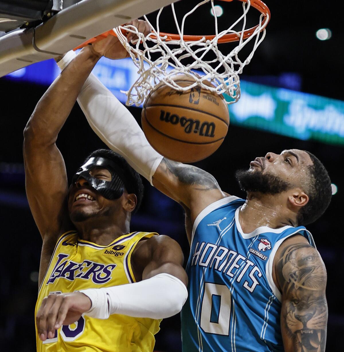  Lakers forward Rui Hachimura (28) slam dunks over Charlotte Hornets forward Miles Bridges (0) at Crypto.Com Arena. 