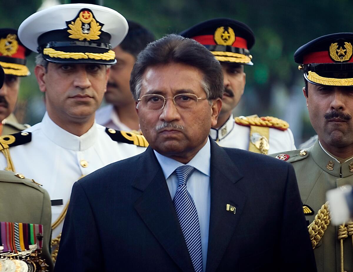 FILE - Outgoing President Pervez Musharraf is surrounded by top military officers as he leaves the Presidential House in Islamabad, Pakistan on Aug. 18, 2008, file photo. Musharraf, Pakistan's former military ruler, is critically ill and has been hospitalized in Dubai since last month, his family said Friday, June 10, 2022. (AP Photo/Emilio Morenatti, File)