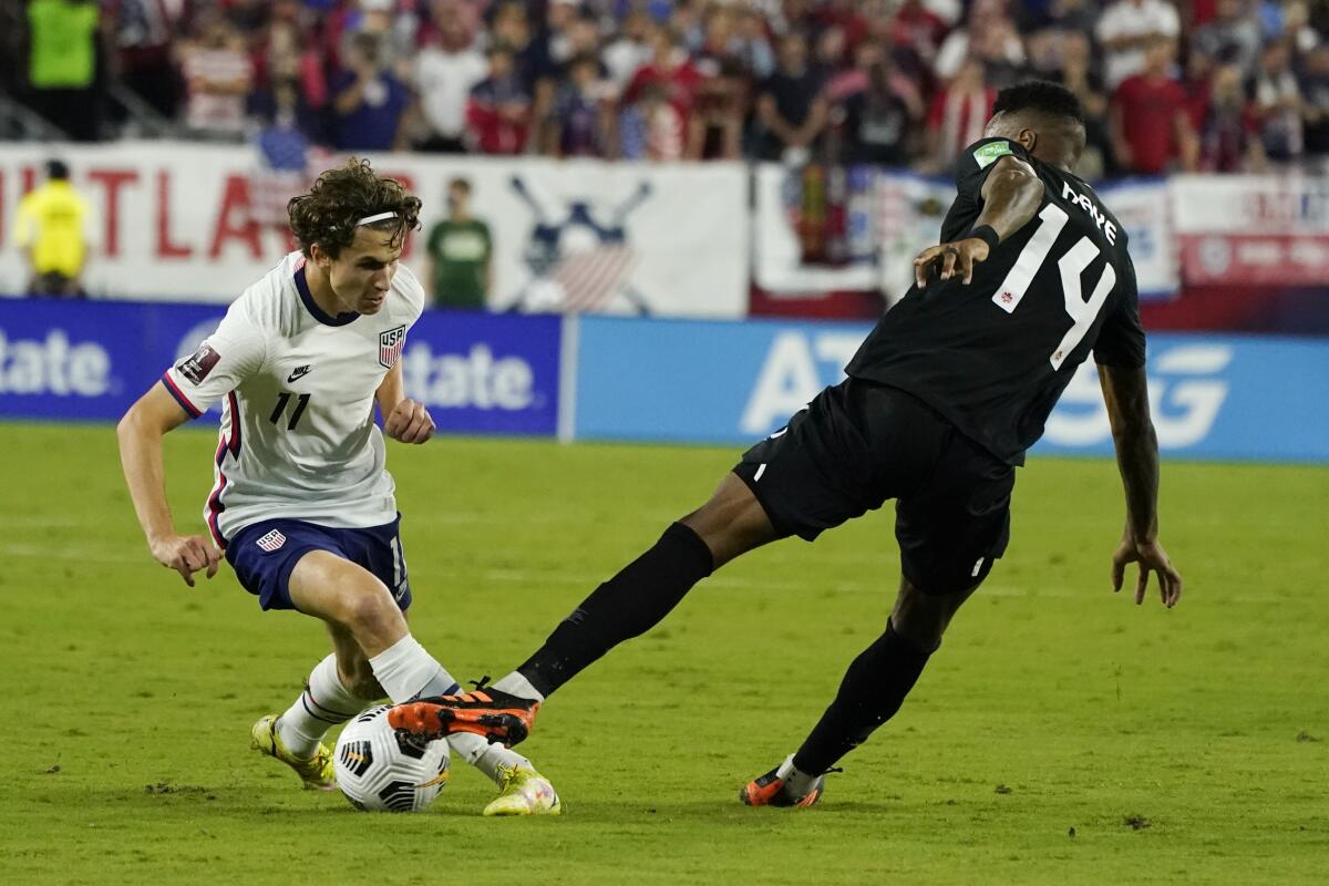 U.S. forward Brenden Aaronson, left, controls the ball in front of Canada midfielder Mark-Anthony Kaye.
