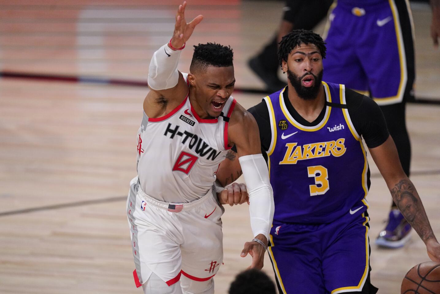The Rockets' Russell Westbrook, left, loses the ball while being defended by the Lakers' Anthony Davis on Friday.