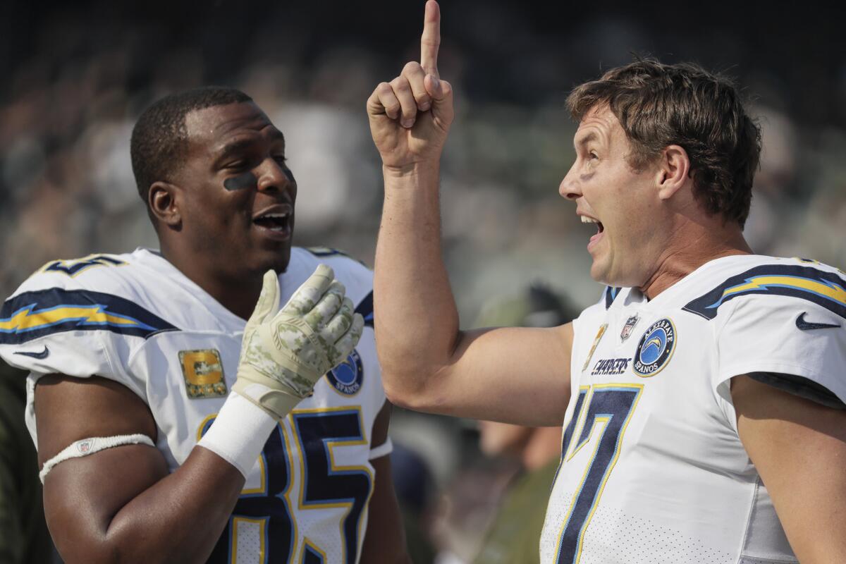 Antonio Gates, left, and Philip Rivers share a moment on the sidelines, something they've done for the previous 15 seasons.
