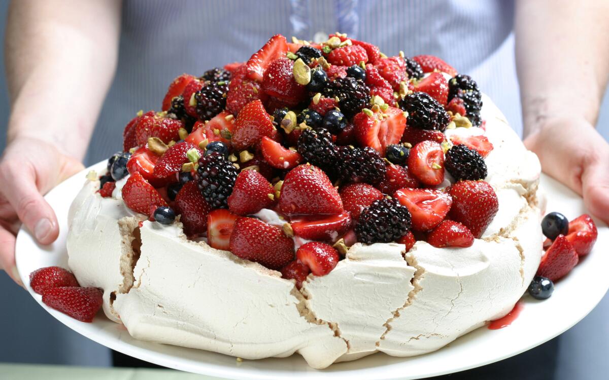 Berry Pavlova with vanilla whipped cream and pistachios