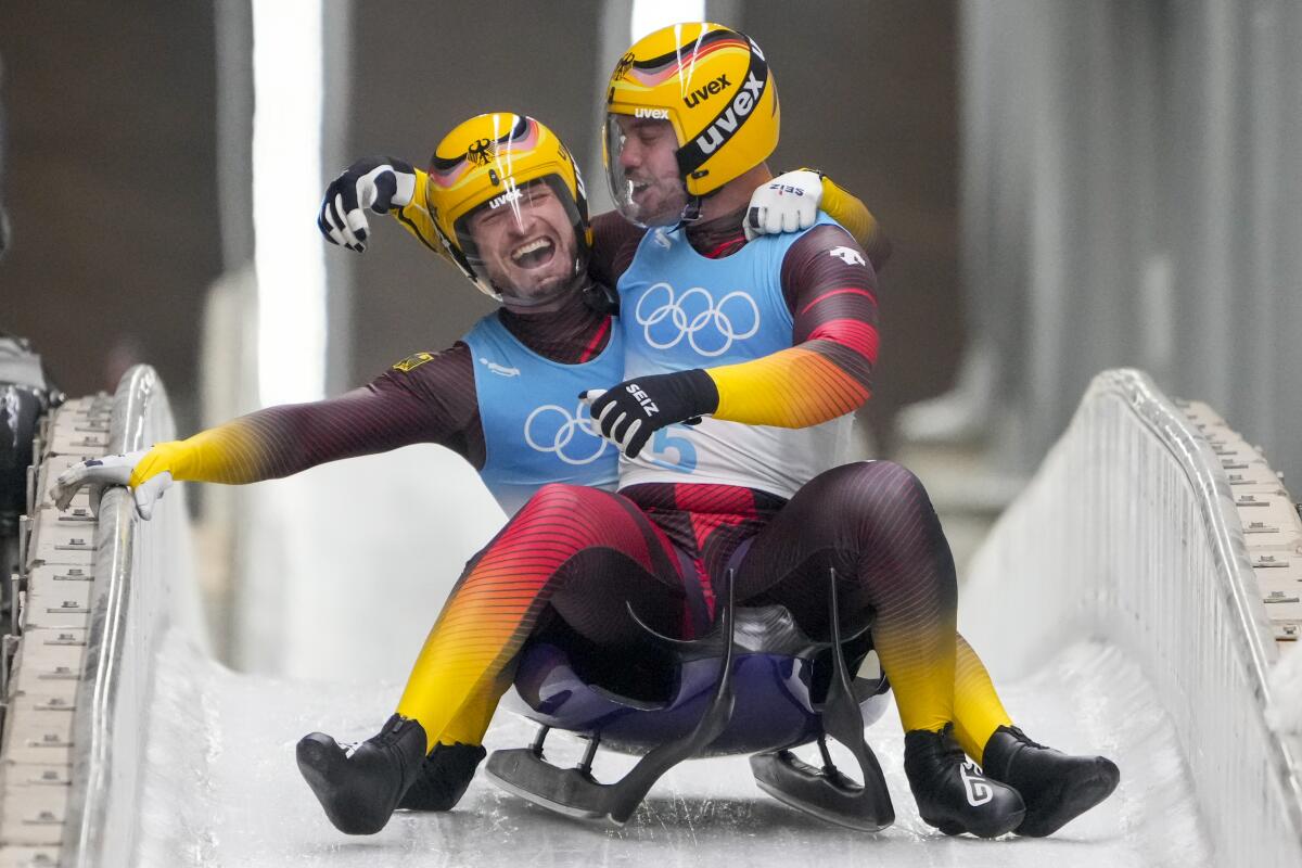 Tobias Wendl and Tobias Arlt of Germany celebrate winning the gold medal in luge doubles at the 2022 Winter Olympics.