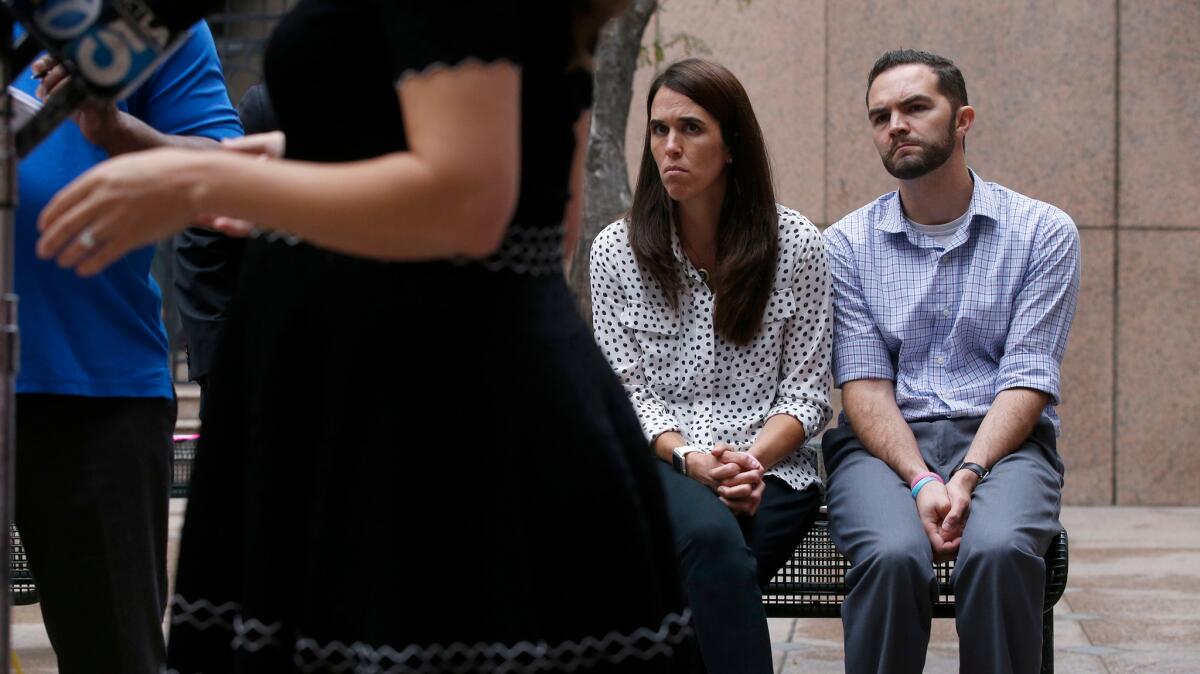 Summer and Rusty Page listen to their attorney, Lori Alvino McGill, after an appeals court hearing in downtown Los Angeles in June. They've pledged to take their fight to the state Supreme Court.