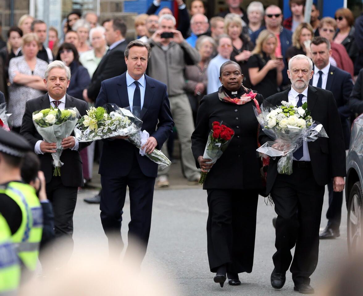 British Prime Minister David Cameron, second to left, Labour Party leader Jeremy Corbyn, right, House of Commons speaker John Bercow, left, and Speaker's chaplain Reverend Rose Hudson-Wilkin arrive to leave flowers near the scene where Labour MP Jo Cox was fatally wounded in Birstall, northern England on June 17, 2016.