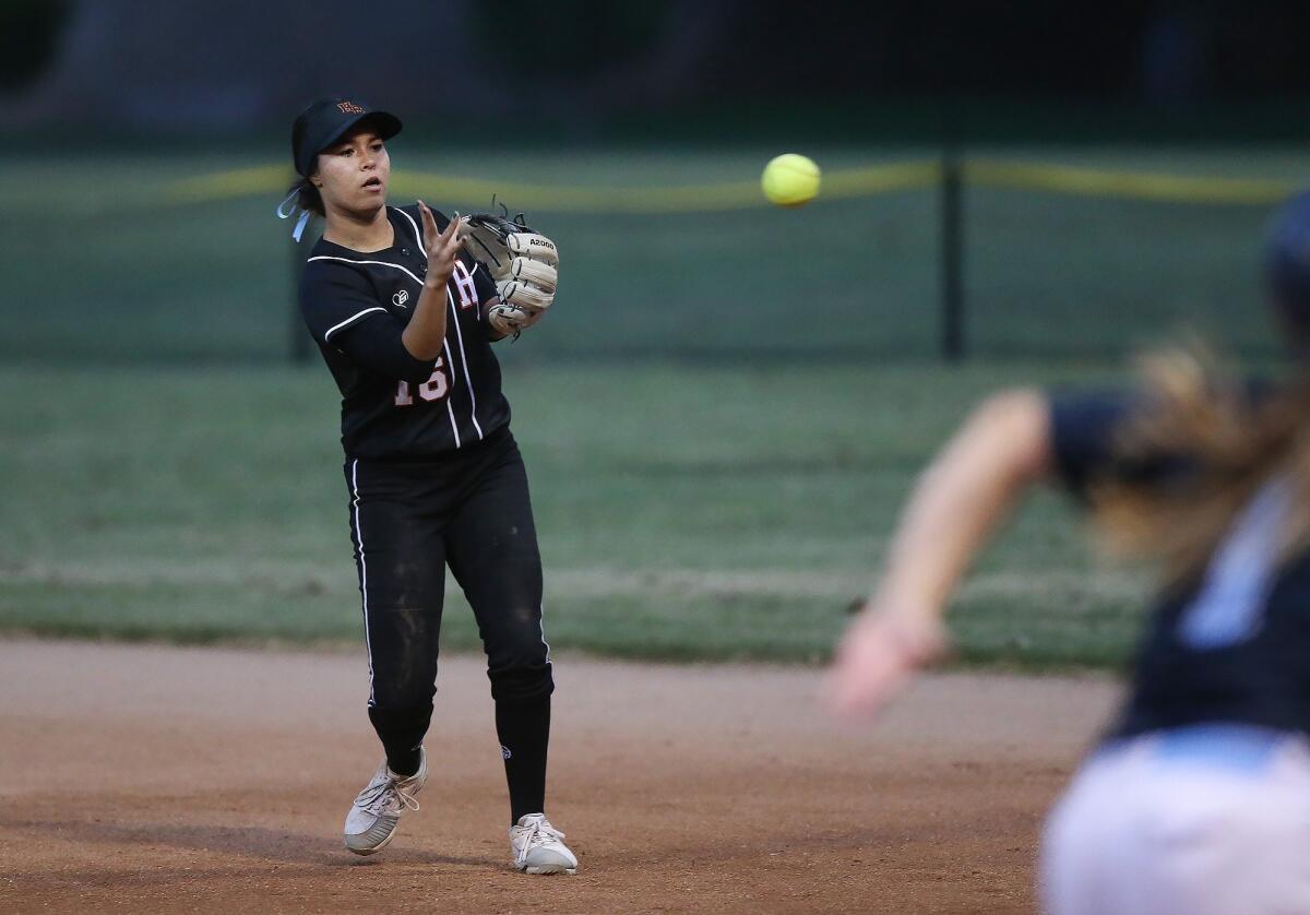 Huntington Beach High second baseman Megan Ryono throws out a runner during the Michelle Carew Classic game against El Cajon Granite Hills at Peralta Canyon Park in Anaheim on Thursday.