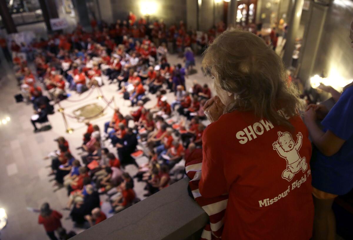 Elizabeth War looks over a gathering of her fellow abortion opponents in the Missouri Capitol rotunda Wednesday, where lawmakers overrode a veto by Gov. Jay Nixon of legislation requiring a 72-hour waiting period for abortions.