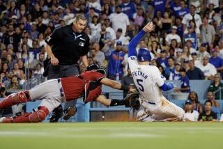 LOS ANGELES, CA - JULY 3, 2024: Los Angeles Dodgers first base Freddie Freeman (5) is tagged out at home plate by Arizona Diamondbacks catcher Gabriel Moreno (14) in the third inning at Dodgers Stadium on July 3, 2024 inLos Angeles, California.(Gina Ferazzi / Los Angeles Times)