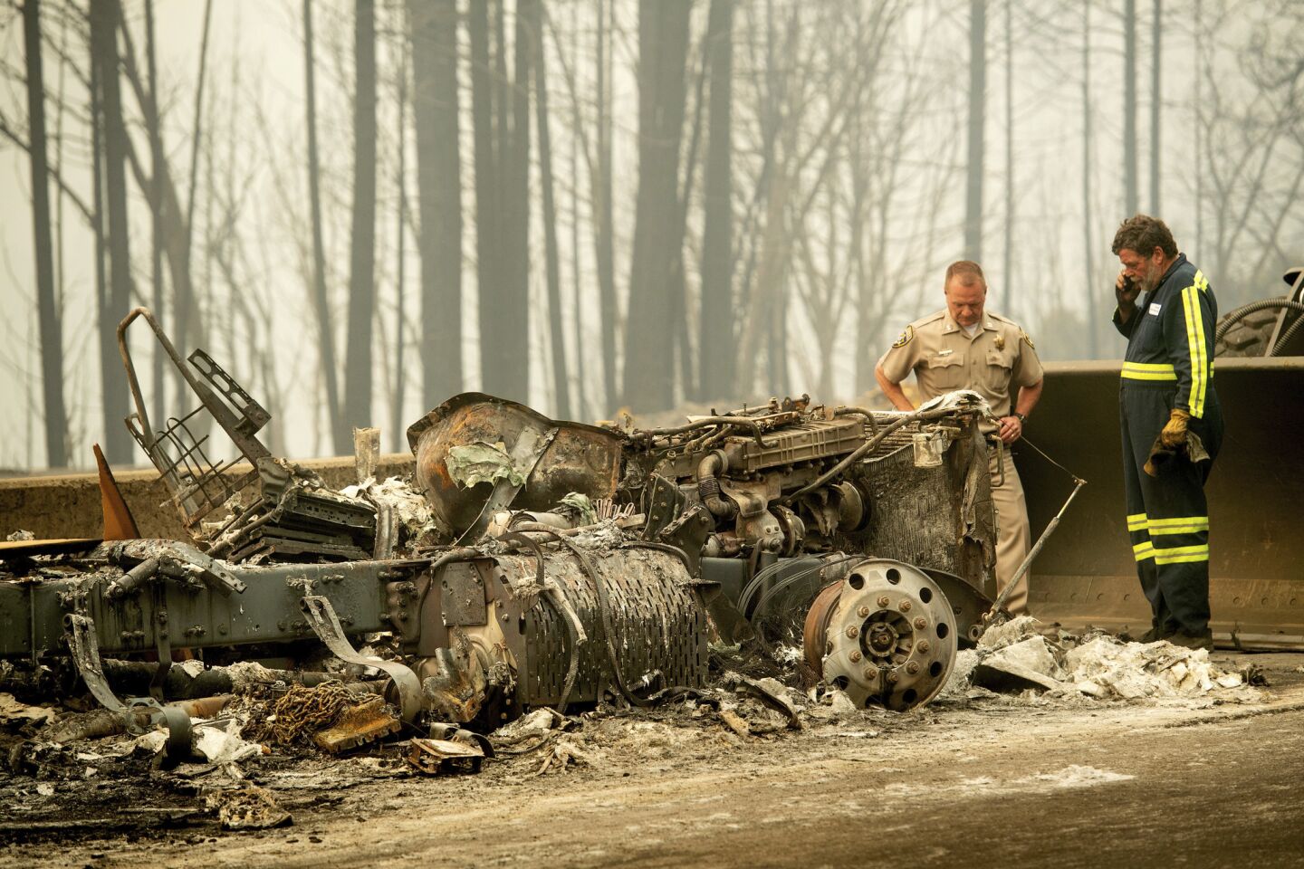 California Highway Patrol Capt. Mark Loveless examines a truck scorched by the Delta fire burning along Interstate 5 in the Shasta-Trinity National Forest.