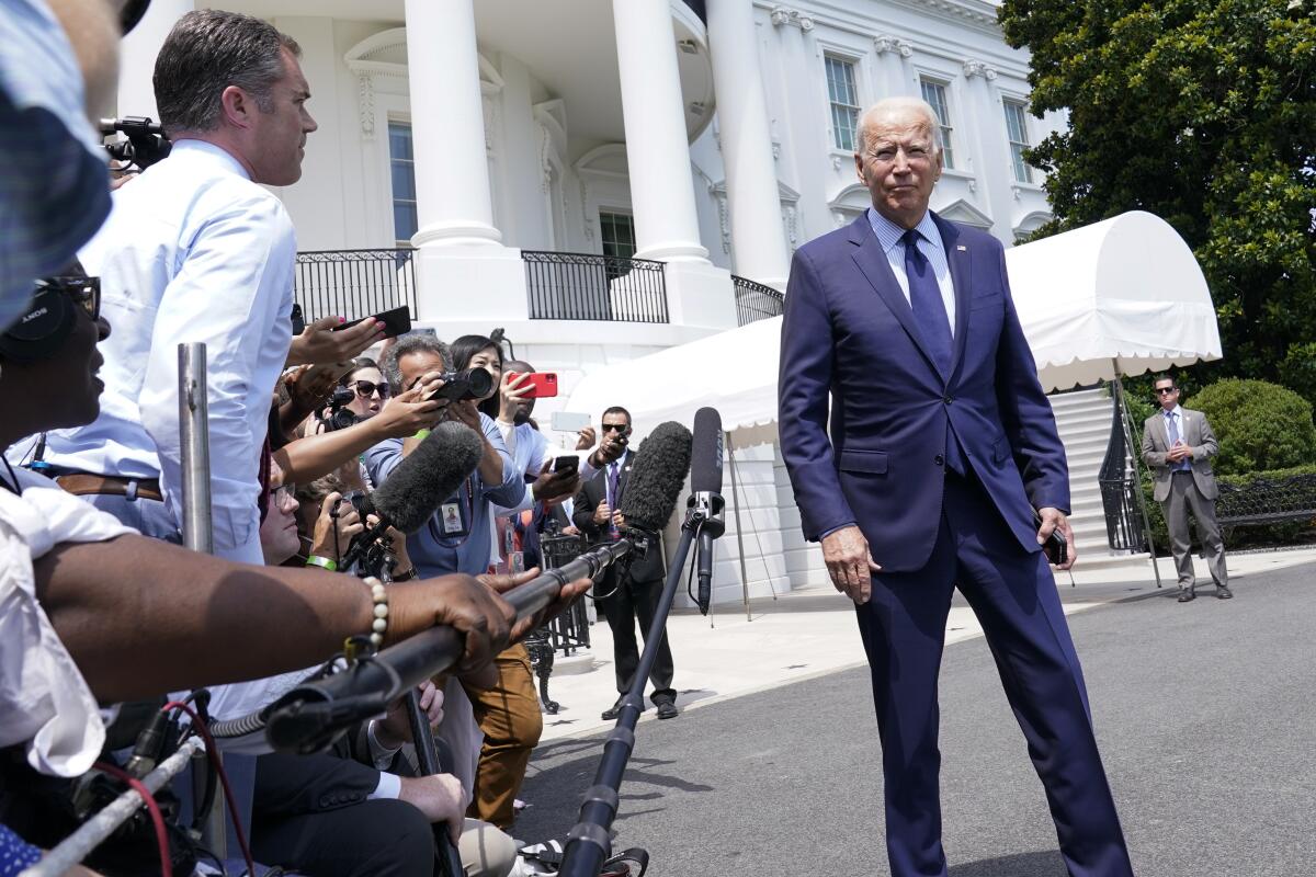 President Biden talks to reporters outside the White House