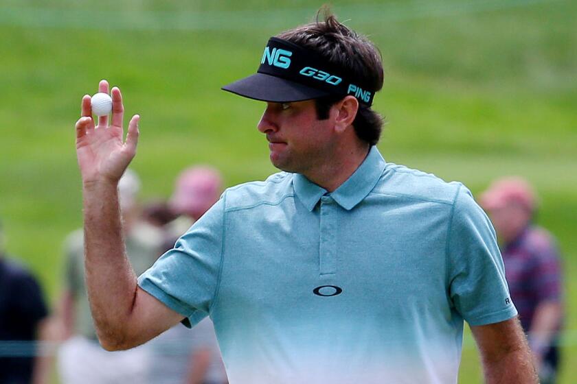 Bubba Watson acknowledges the cheers from the gallery after sinking a putt on the seventh green during the second round of the Travelers Championship at TPC River Highlands in Cromwell, Conn., on Friday.