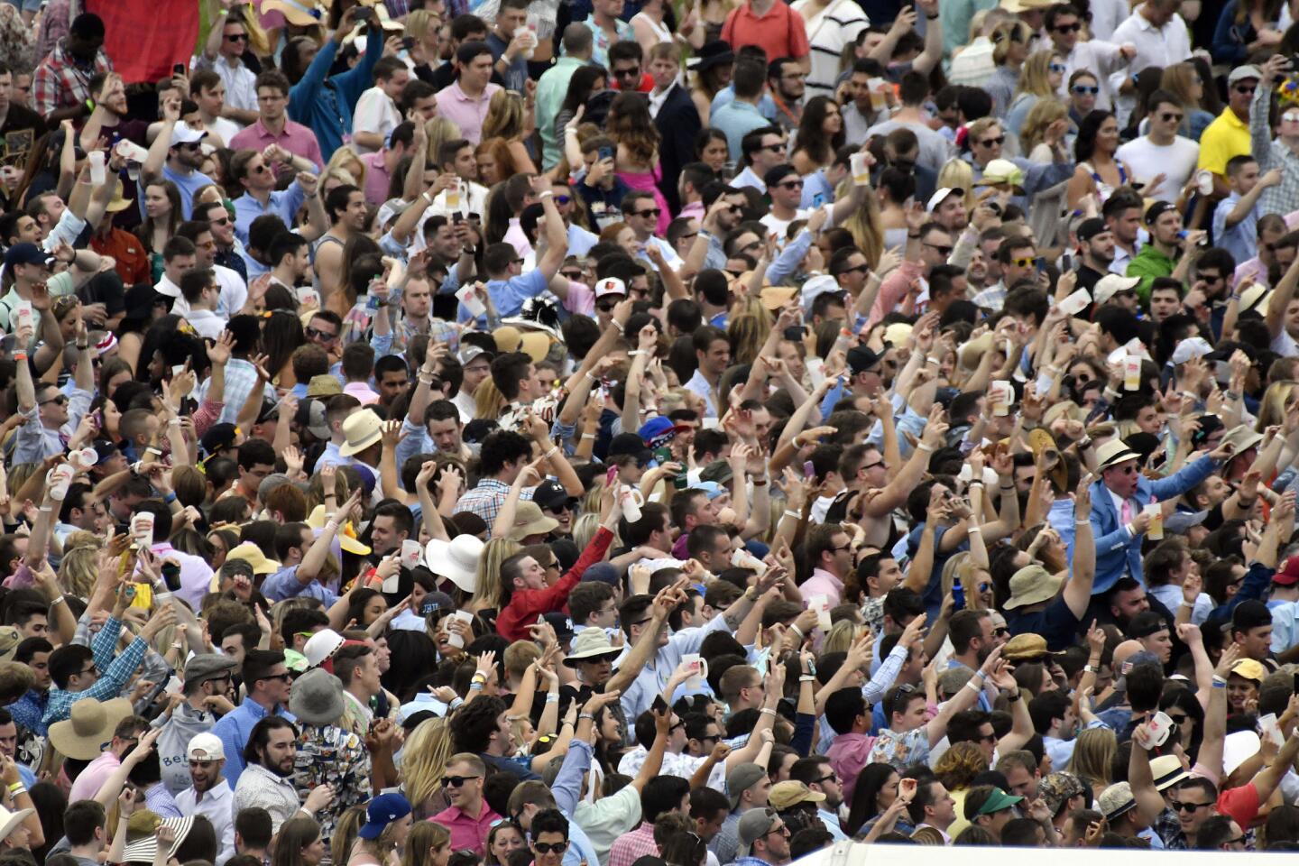 The infield crowd dances to the music of ZEDD before the running of he 142nd Preakness.