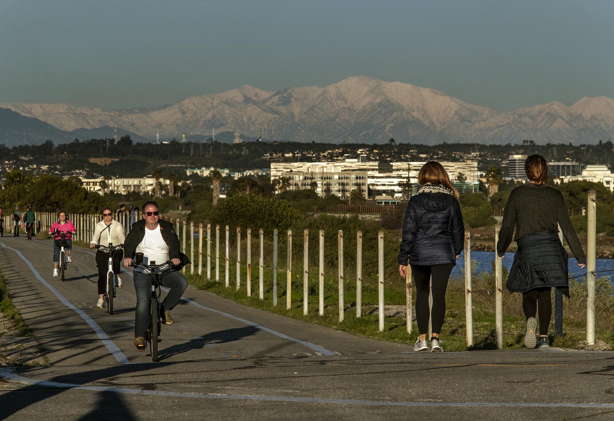 A bike trail with a snow-capped mountain as a backdrop.