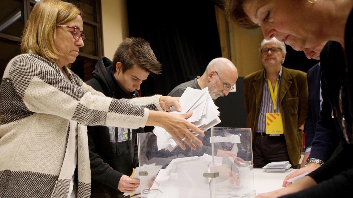 Officials count votes for regional elections at a polling station in Barcelona, Spain, on Dec. 21, 2017.