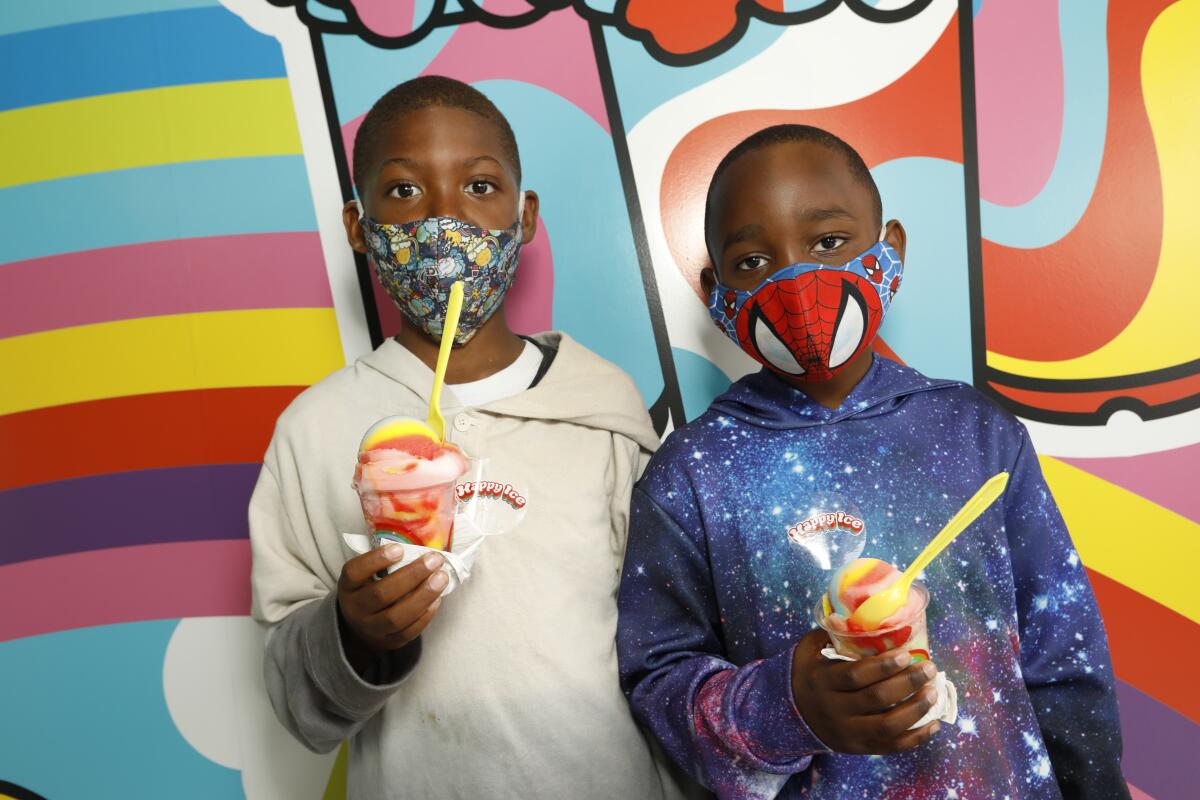 Daylin White, 8, and Jace Knot, 6, attend the opening of Happy Ice on Melrose Ave on June 20, 2020.
