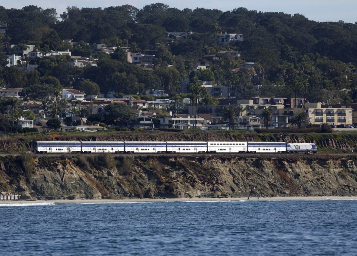 The Amtrak Surfliner train heads north along the tracks in Del Mar on Dec. 5, 2019. Trains were slowed down while passing through the area following a bluff collapse in November that required emergency stabilization of the cliff.