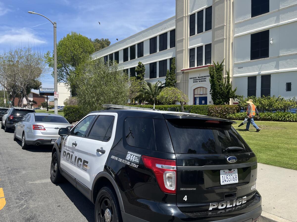 A black-and-white SUV marked "Los Angeles School Police" parked in front of George Washington Preparatory High School
