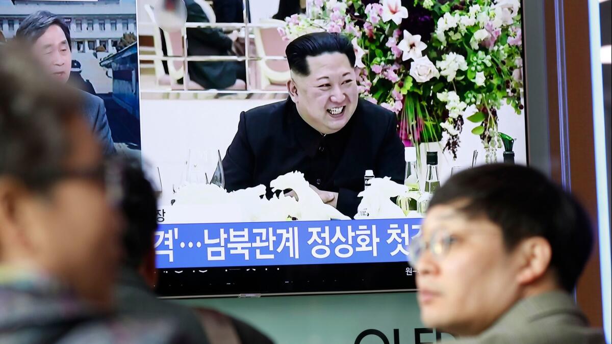 South Koreans watch a television displaying news broadcasts in Seoul, South Korea Wednesday, a day after officials announced that leaders of North and South Korea would hold a summit in late April.