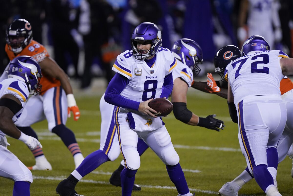 Minnesota Vikings quarterback Kirk Cousins looks to hand the ball off during the first half against the Chicago Bears.
