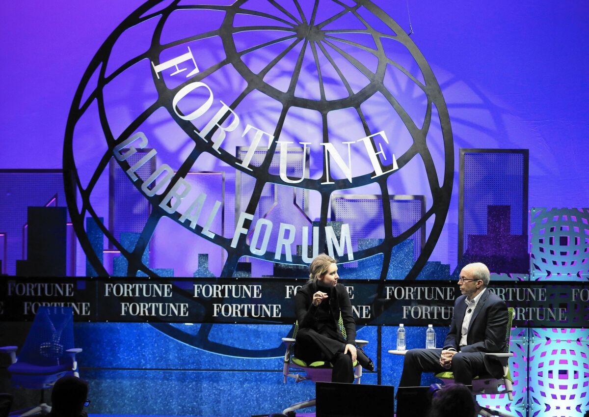 Theranos is losing business deals, according to a recent report. Above, Elizabeth Holmes, founder and chief executive of Theranos, left, speaks at the Fortune Global Forum in San Francisco last month.