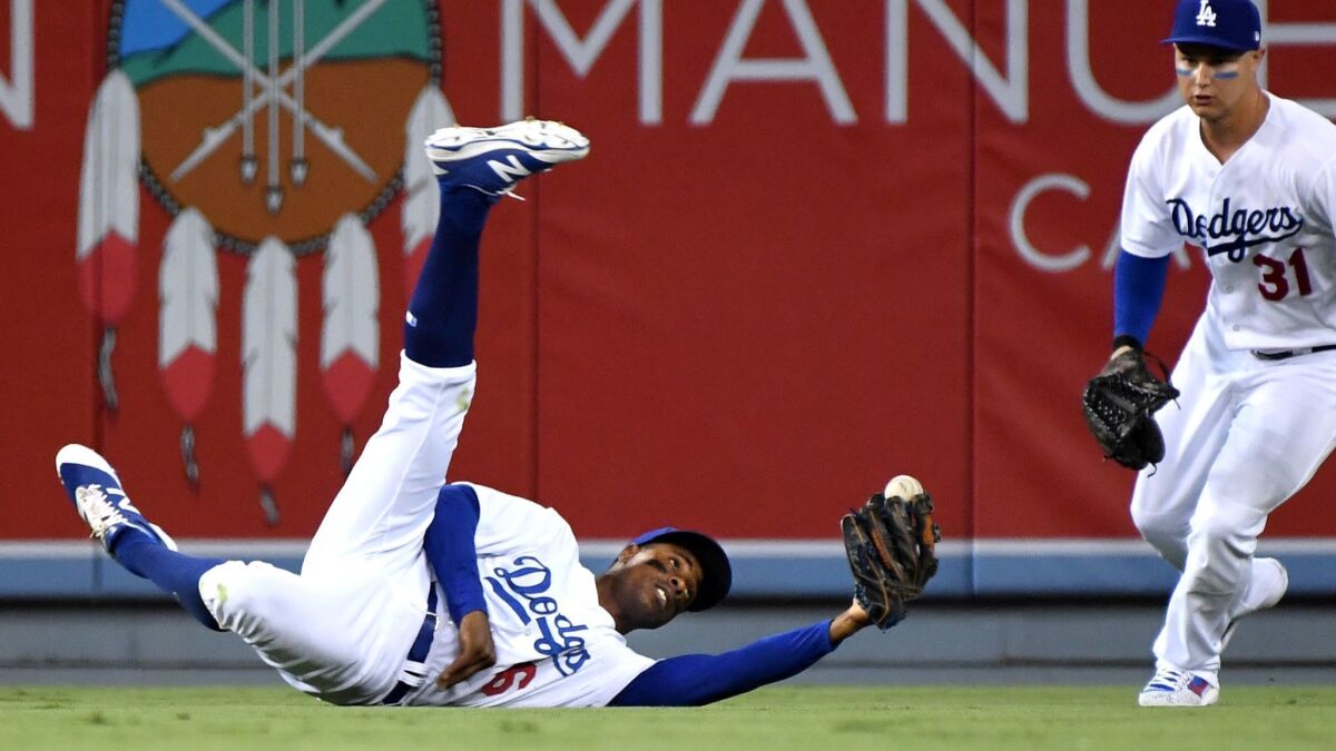Curtis Granderson makes a diving catch during his stint with the Dodgers last season.