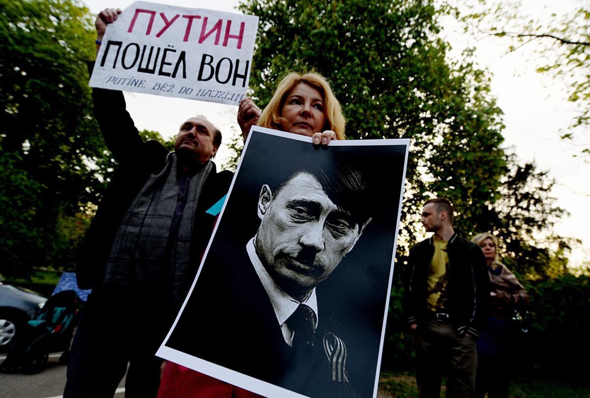 Protesters in the Czech Republic compare Vladimir Putin to Hitler in objecting to Russia's takeover of Crimea.