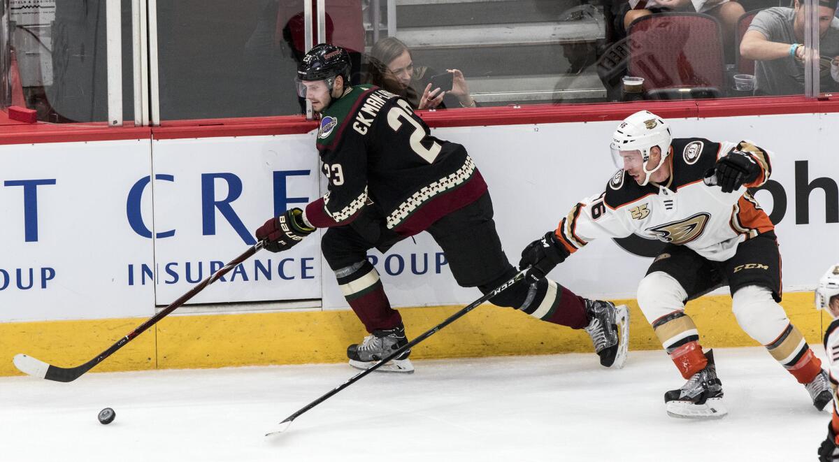 Arizona Coyotes' Oliver Ekman-Larsson (23) and Ducks' Ben Street (46) chase the puck during the third period on Saturday in Glendale, Ariz.